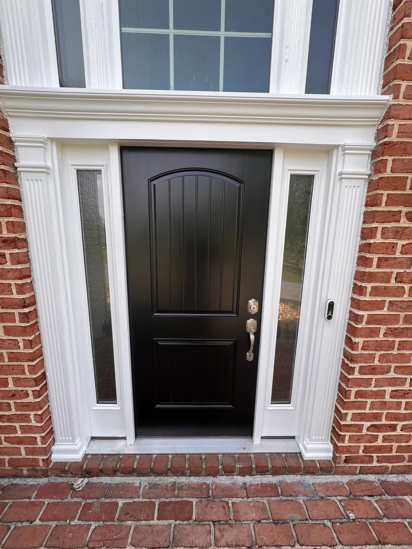 Black front entry door painted by Premier Painting Solutions