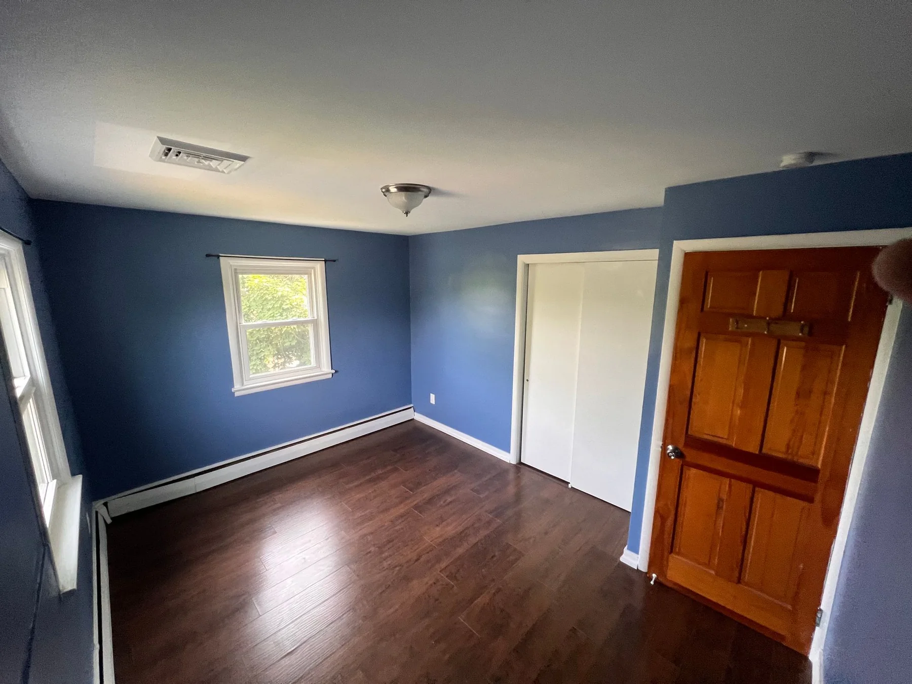Blue bedroom interior painting by Premier Painting Solutions