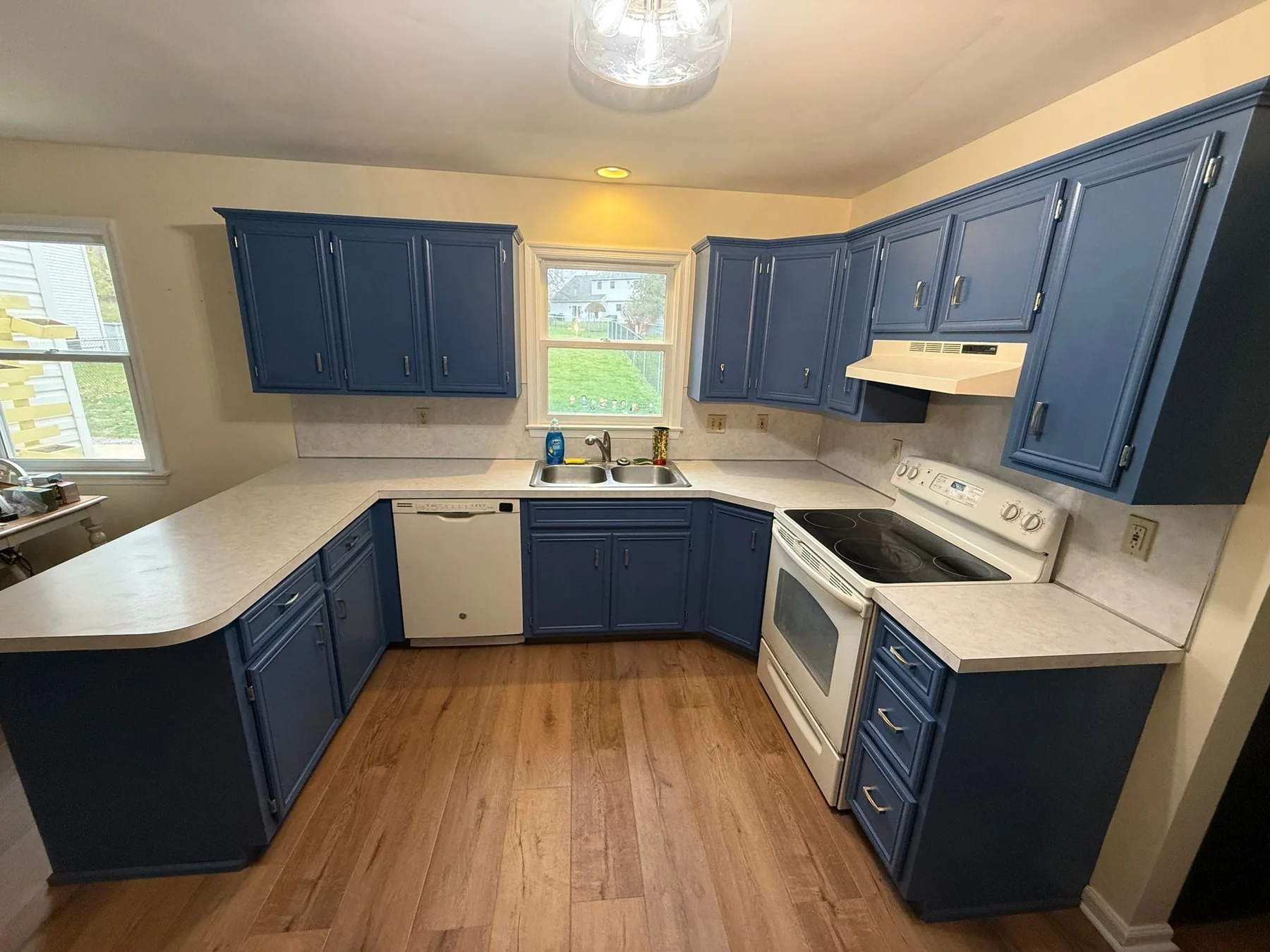 Blue kitchen cabinets refinished by Premier Painting Solutions