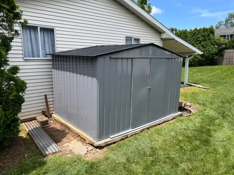Gray shed exterior painting by Premier Painting Solutions