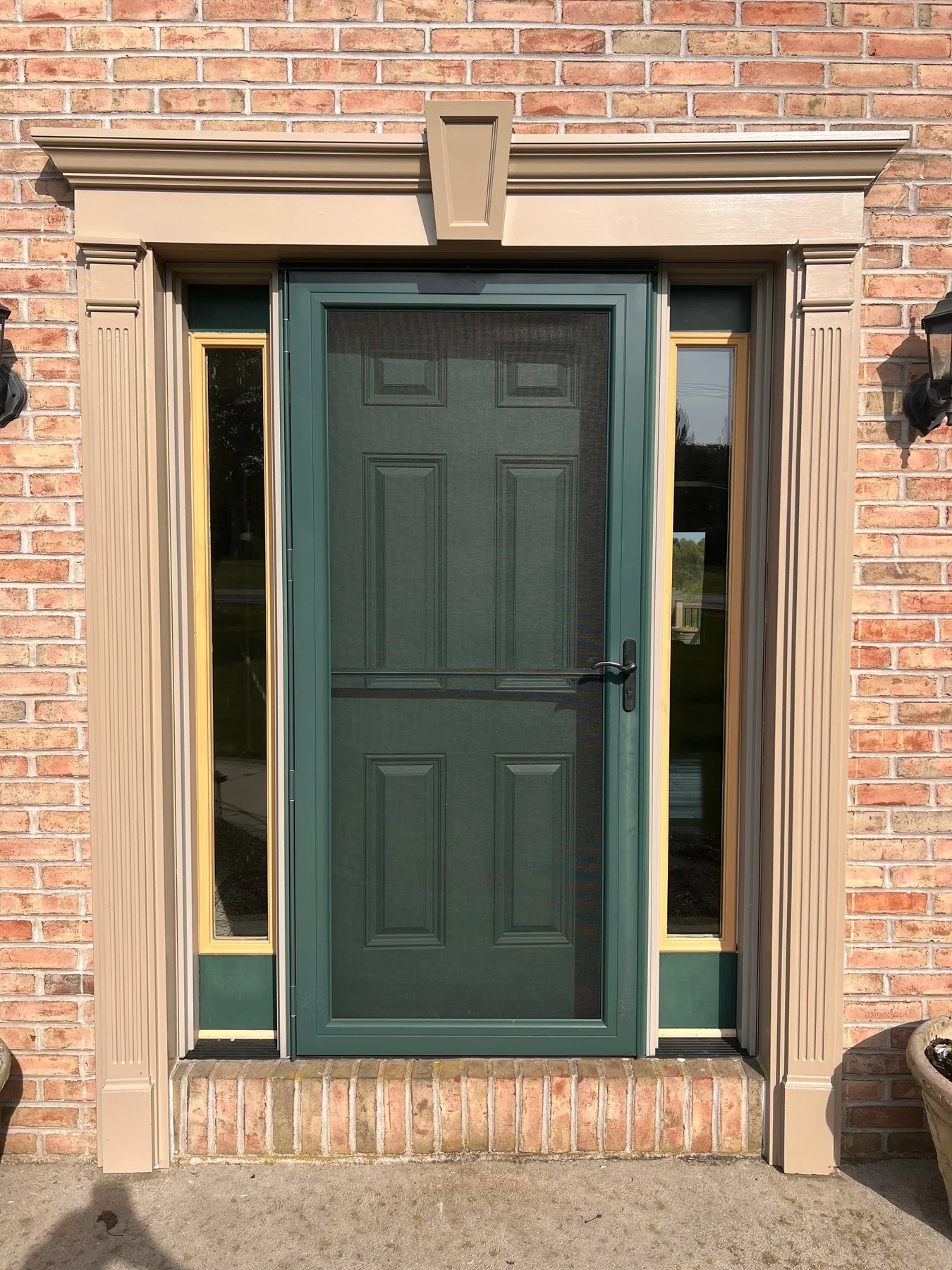 Green front entry door painted by Premier Painting Solutions
