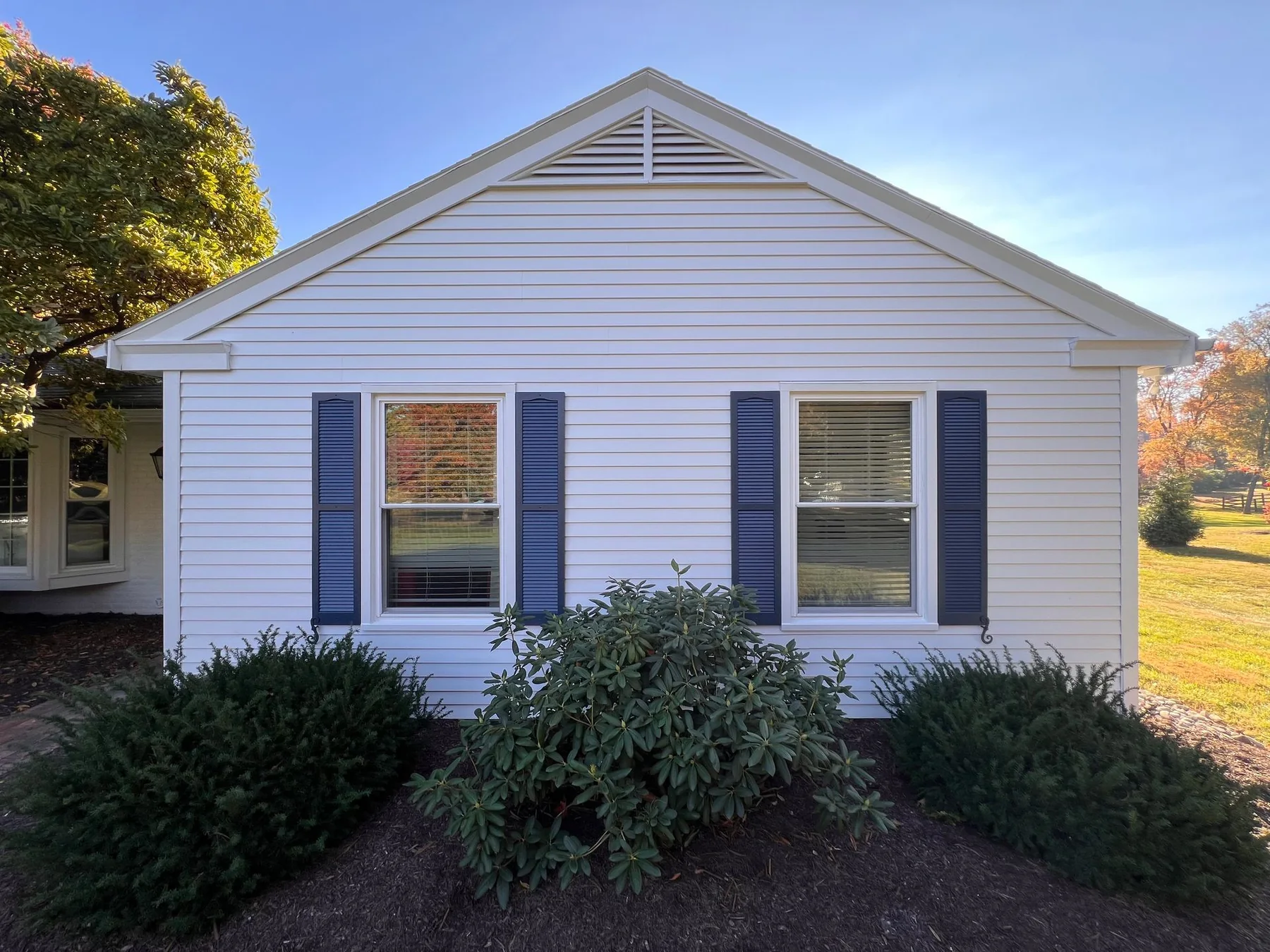 White home exterior and shutters painted by Premier Painting Solutions